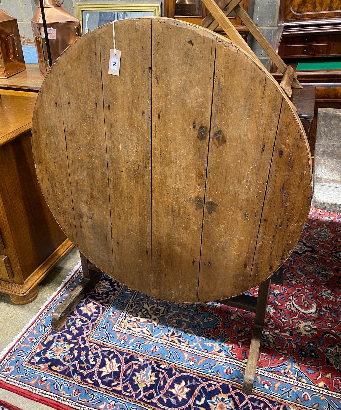 A 19th century French circular fruitwood folding dining table, diameter 101cm, height 74cm